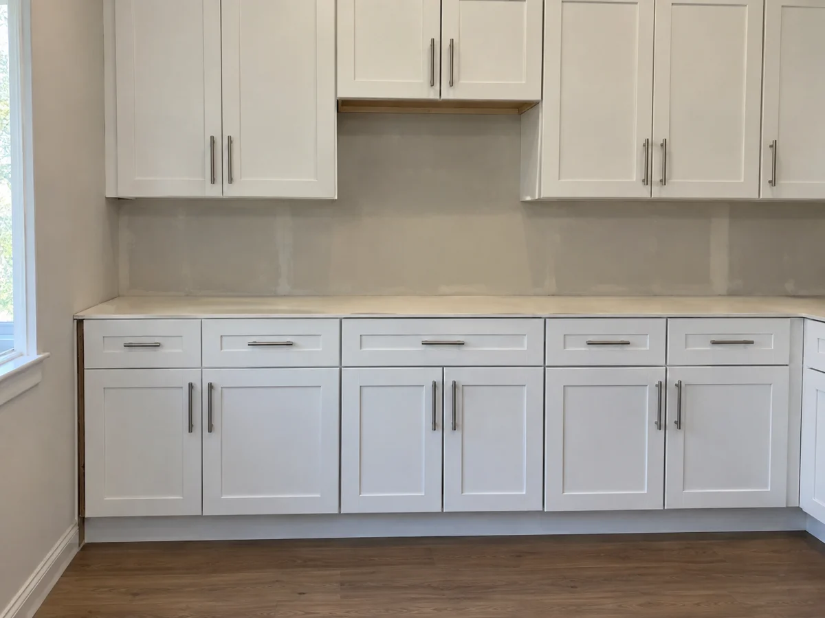 Installed white shaker kitchen cabinets with a left filler gap